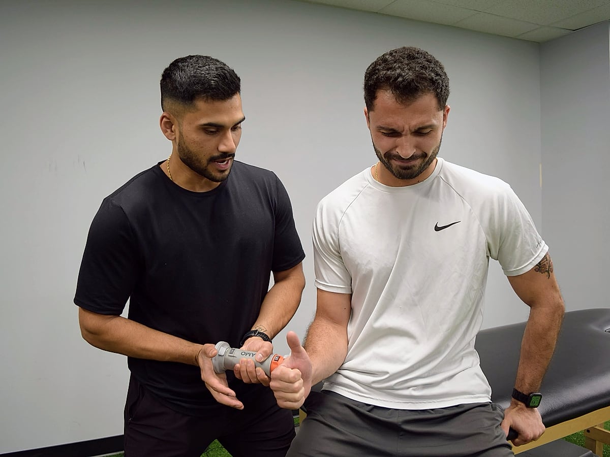 Therapist coaching a patient through a return-to-sport rehab exercise